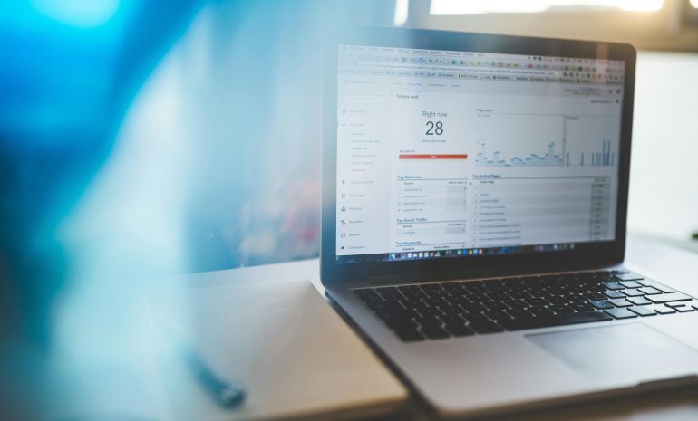 Laptop displaying Google Analytics in a modern workspace, highlighting digital analytics and technology.